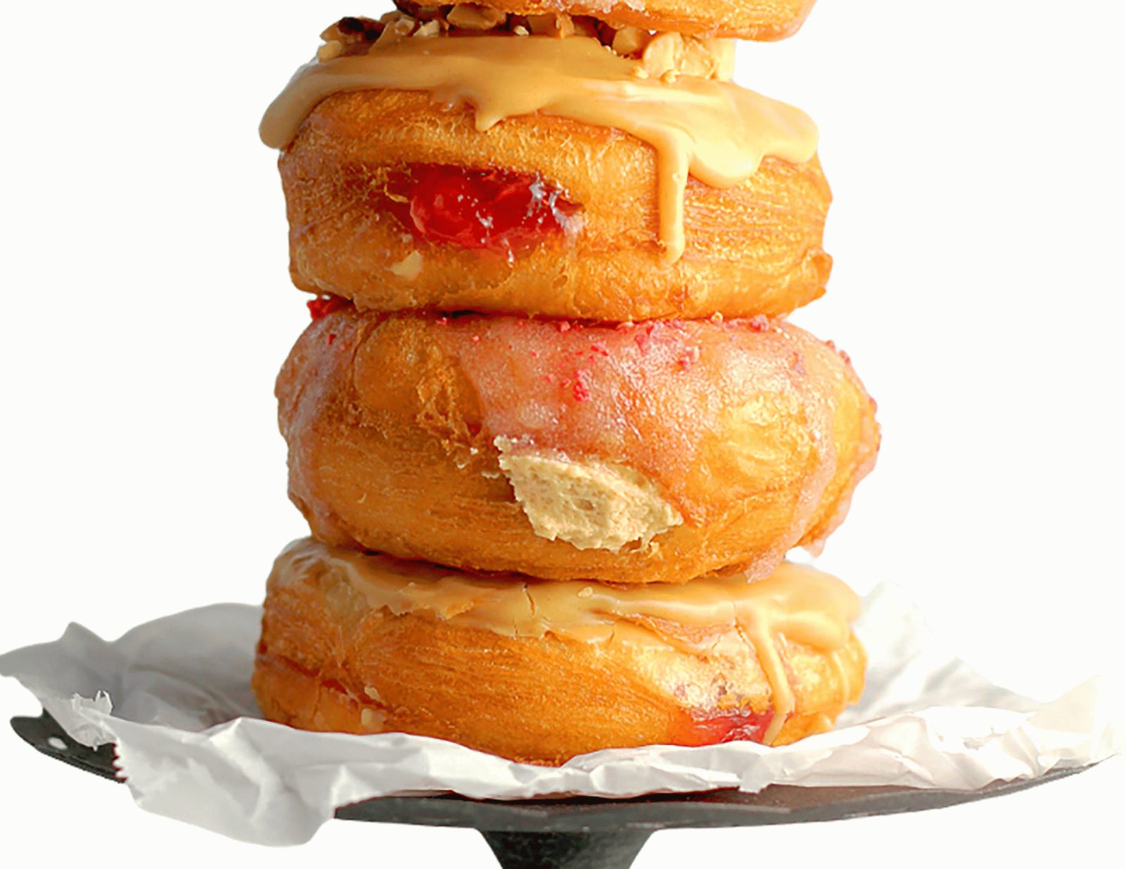 A stack of glazed and jam-filled donuts