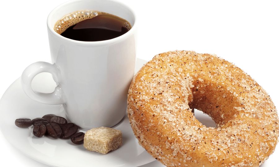 A cinnamon sugar donut with a cup of coffee