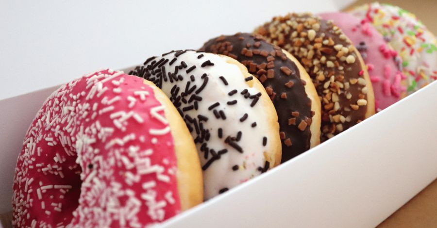 A box of sprinkled and chocolate donuts